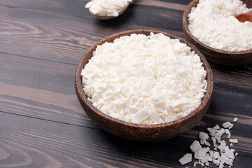 Set for crafting candle on wooden background. Eco soy wax and candle making tools top view, flat lay