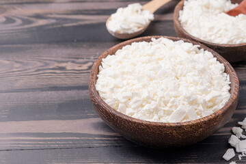 Set for crafting candle on wooden background. Eco soy wax and candle making tools top view, flat lay