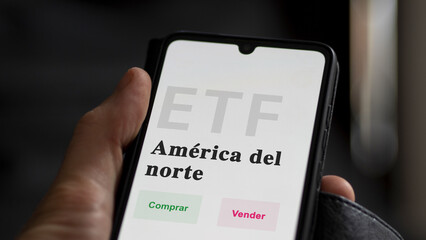 An investor analyzing an etf fund. ETF text in Spanish : North America, buy, sell.