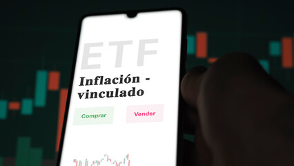 An investor analyzing an etf fund. ETF text in Spanish : inflation - linked, buy, sell.