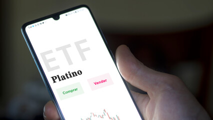 An investor analyzing an etf fund. ETF text in Spanish : platinum, buy, sell.
