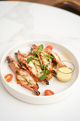 Grilled shrimp and sauce in a white plate