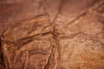 Extreme closeup of crumpled brass foil texture