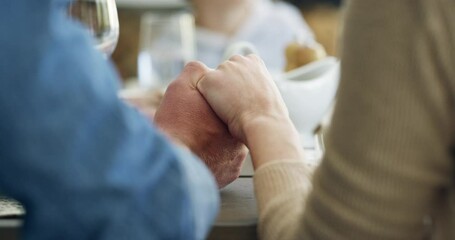 Food, holding hands and family praying at a table for dinner, lunch or holiday celebration. Man and woman or couple of friends together for thanksgiving prayer for hope, support and love or kindness