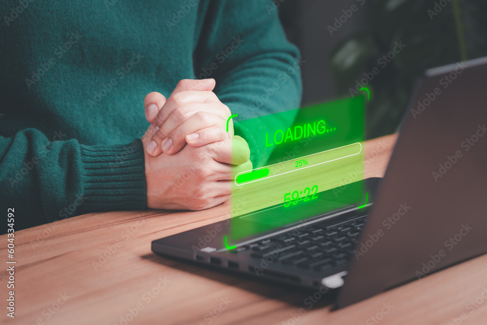 Poster User man using a laptop computer for download and update software with waiting to loading digital file data form website, very slow internet form wifi. Concept of waiting for load of loading symbol.
