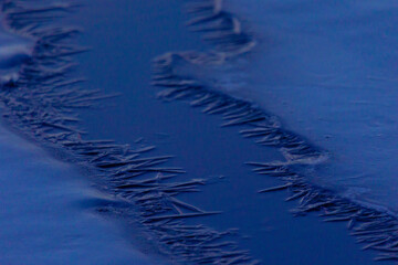 Frozen Serenity: Winter's Icy Embrace on the River in Northern Europe