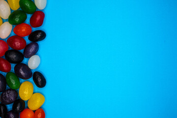colorful jellybeans isolated on blue