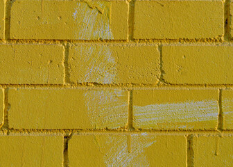 A close up of a brick wall painted over