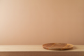 Empty wooden plate on table over modern  background. Kitchen mock up for design and product display