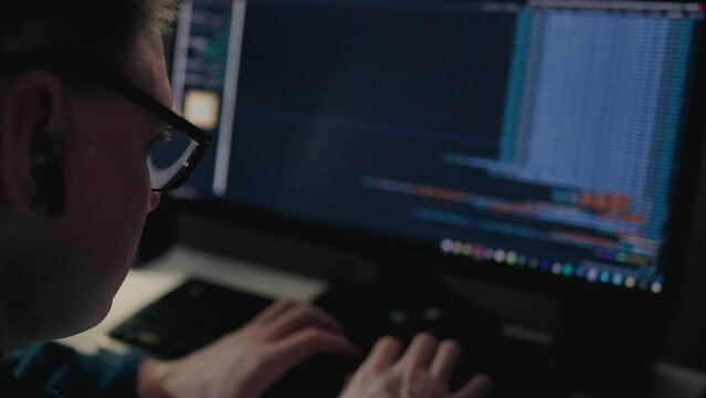 Late into the night, a programmer sits at their desk illuminated by the soft glow of a desk lamp. as they intently work on a complex programming task, fueled by passion and determination
