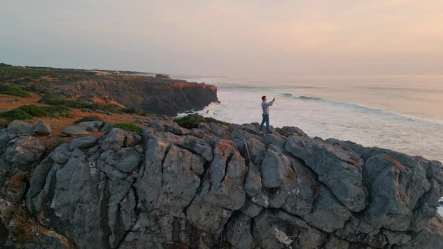 Traveler taking picture sunset ocean. Sea waves reflecting sun. Marine nature