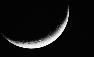 Close-up of a crescent moon on a cold evening in march with a black background.