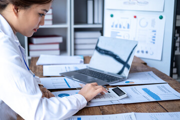 Obraz premium Accountant using calculator and writing on paper, Business woman working audit calculating price taxes loan rates, bookkeeper or financial inspector hand making result