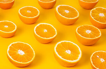 Oranges Cut In Half On A Yellow Background