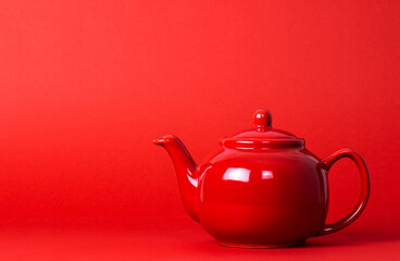 Red Teapot On A Red Background