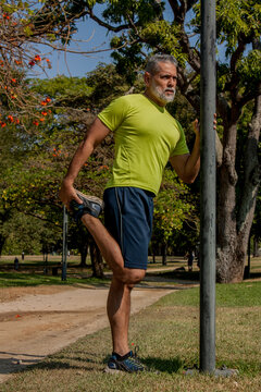 50 year old man jogging in the park on a beautiful sunny day