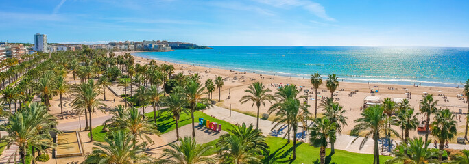 Beach, blue sea and palm trees in Salou city, Catalonia, Spain, Europe - obrazy, fototapety, plakaty