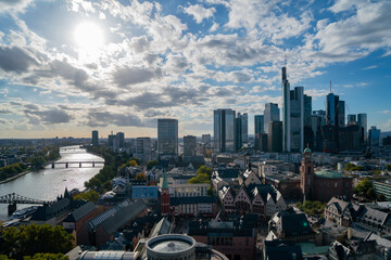Fototapeta na wymiar Stunning of Frankfurt's cityscape with its iconic skyline, skyscrapers, bridge, and river during the day under a partly cloudy autumn sky.