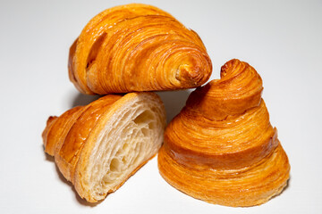 Golden brown butter croissant with shadow isolated on the plain background.