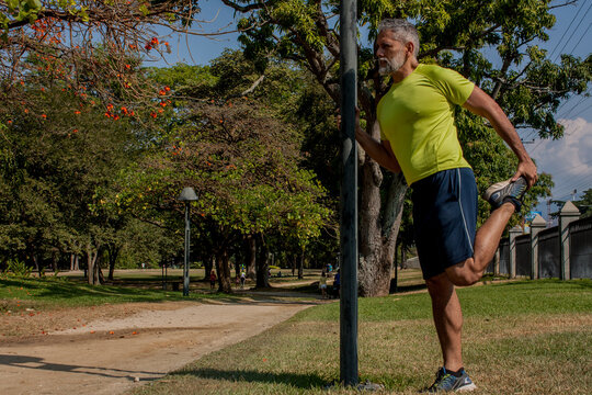 50 Year Old Man Jogging In The Park On A Beautiful Sunny Day