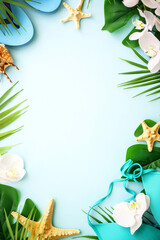 Summer flat lay background. Palm leaves, hat, flip flop and shells on blue. Summer composition with space for design.