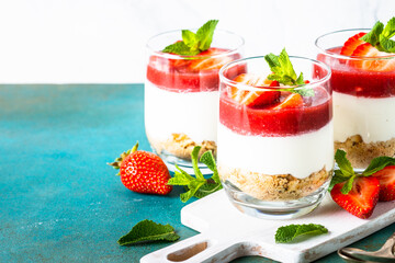 Cheesecake in a glass. Strawberry cheesecake, delicious dessert no baking in jars.