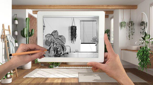 Hands holding and drawing on tablet showing bathroom with houseplants, details CAD sketch. Real finished interior in the background, architecture design presentation