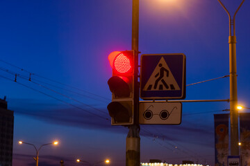 Traffic light on the background of the evening city.