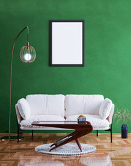 Empty photo frame mockup hanging on green wall background.