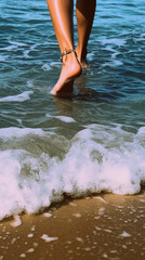 Woman feet in the waves of the sea