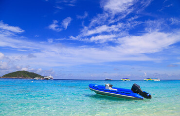 Boats are waiting for tourists on the beach on an island in Thailand with beautiful sea and clear water.