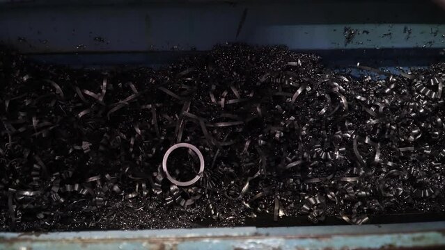 Steel Scrap Moving Scrap Conveyor Lathe Machine,Steel scrap materials recycling. Aluminum chip waste after machining metal parts on a cnc lathe. Closeup twisted spiral steel shavings. Small roughness 