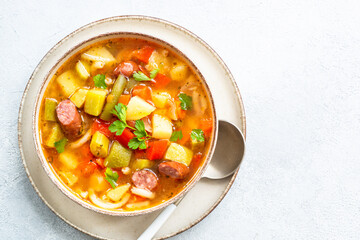 Minestrone soup, italian vegetable soup with smoked sausages, Top view.