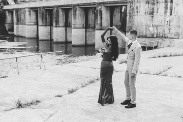 Black and white photo of a teenage couple dressed up for the prom, dancing,