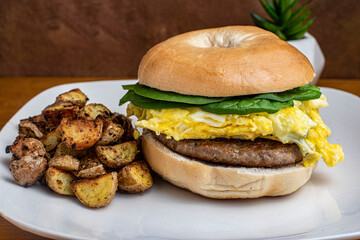 scramble egg  and sausage patty on a bagel,