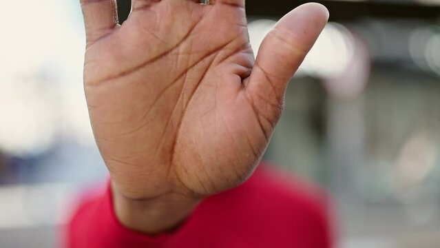 African american woman doing stop gesture with hand at street
