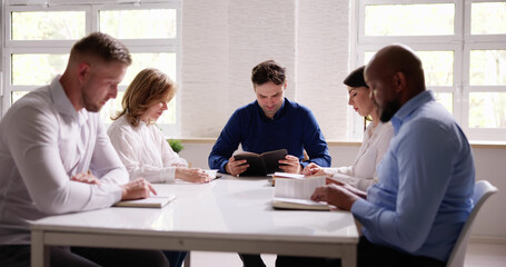 Group Of Young Multiethnic People Reading Bible Over Wooden