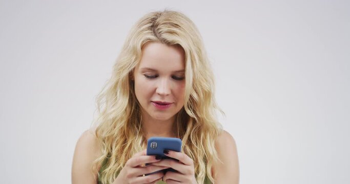 Funny, phone and woman typing in studio isolated on a white background mockup space. Cellphone, comedy and female person on social media, networking or website, internet app and online comic meme.