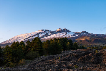 Cold lava flow on mount Etna volcano at sunset