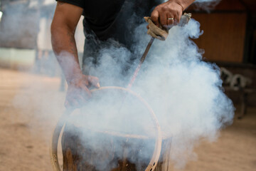 Hands making musical instrument folkloric bass drum in Argentina. Daytime. No face.