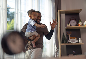 The father embraced and carefully picked up his young son with tenderness and care. Giving...