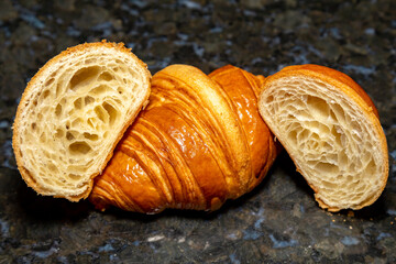 Golden brown butter croissant with shadow isolated on the plain background.