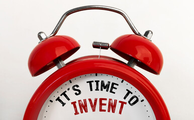 Red alarm clock with text time to invent