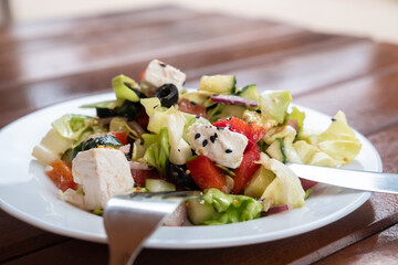Close up vegetable salad with cheese. Side view