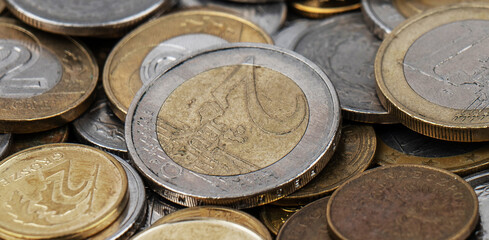 A pile of gold and silver coins.