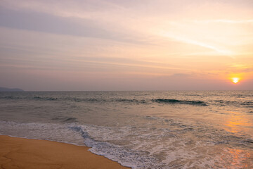 Very nice sunset over the sea at Mai Khao Beach on the island of Phuket in Thailand.