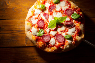 pizza with salami and tomatoes and mozzarella - 604399775