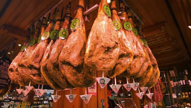 Jamon serrano hanging in market ceiling
