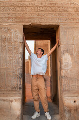 young male traveler visits Kom Ombo Temple at sunset. Egypt. 