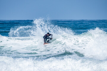 Surfer riding waves in Furadouro Beach